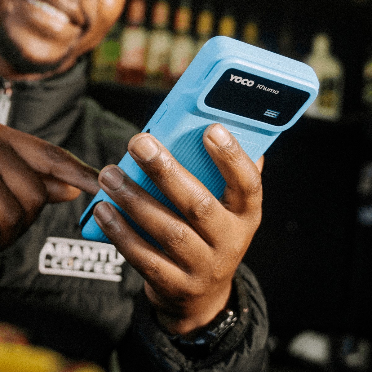 A man holding the Khumo 2 point of sale in his left hand.