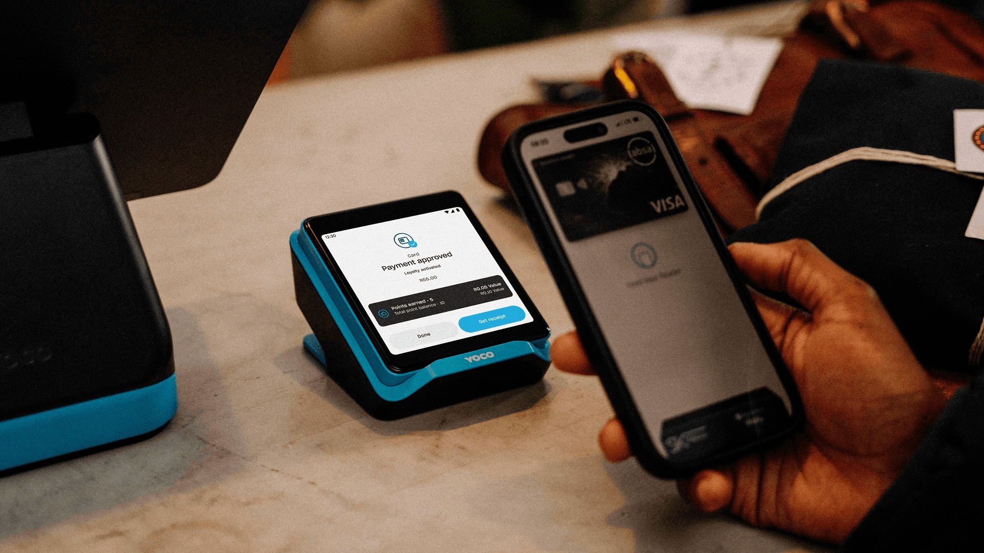 A customer pays with a virtual card on a Yoco point of sale machine